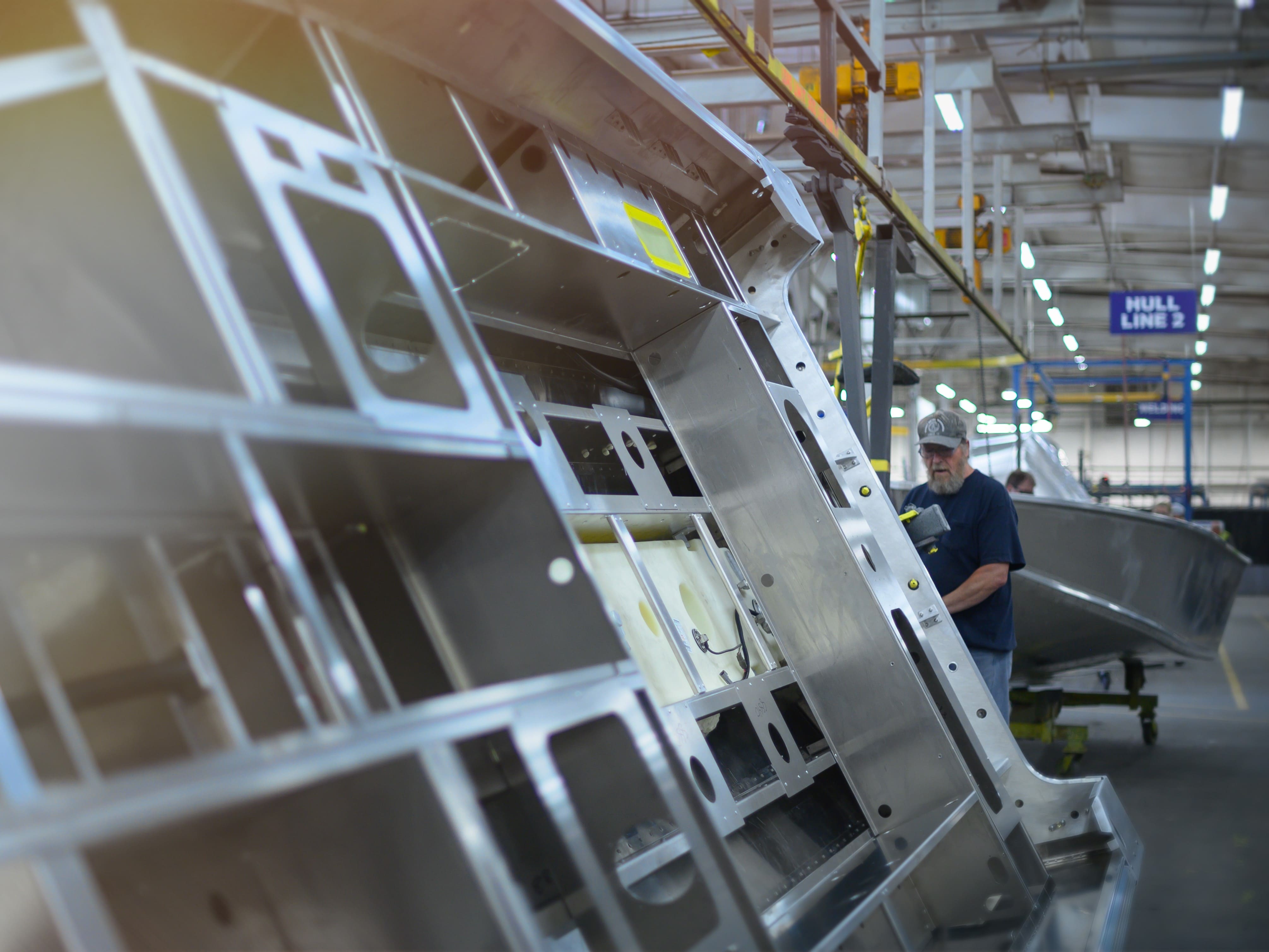 Man building an Alumacraft Aluminum Fishing Boat