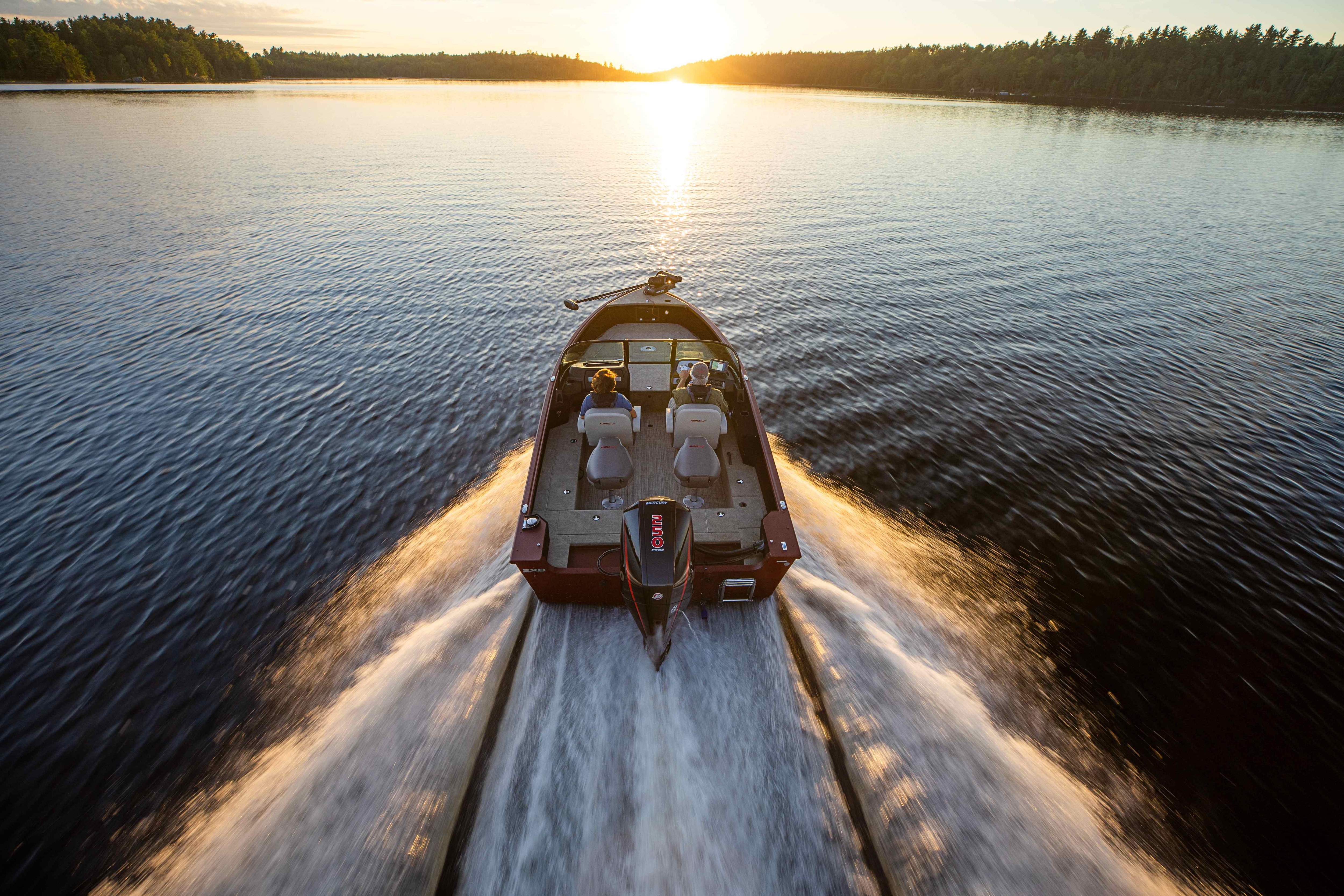 Aluminum boat running at the sunset