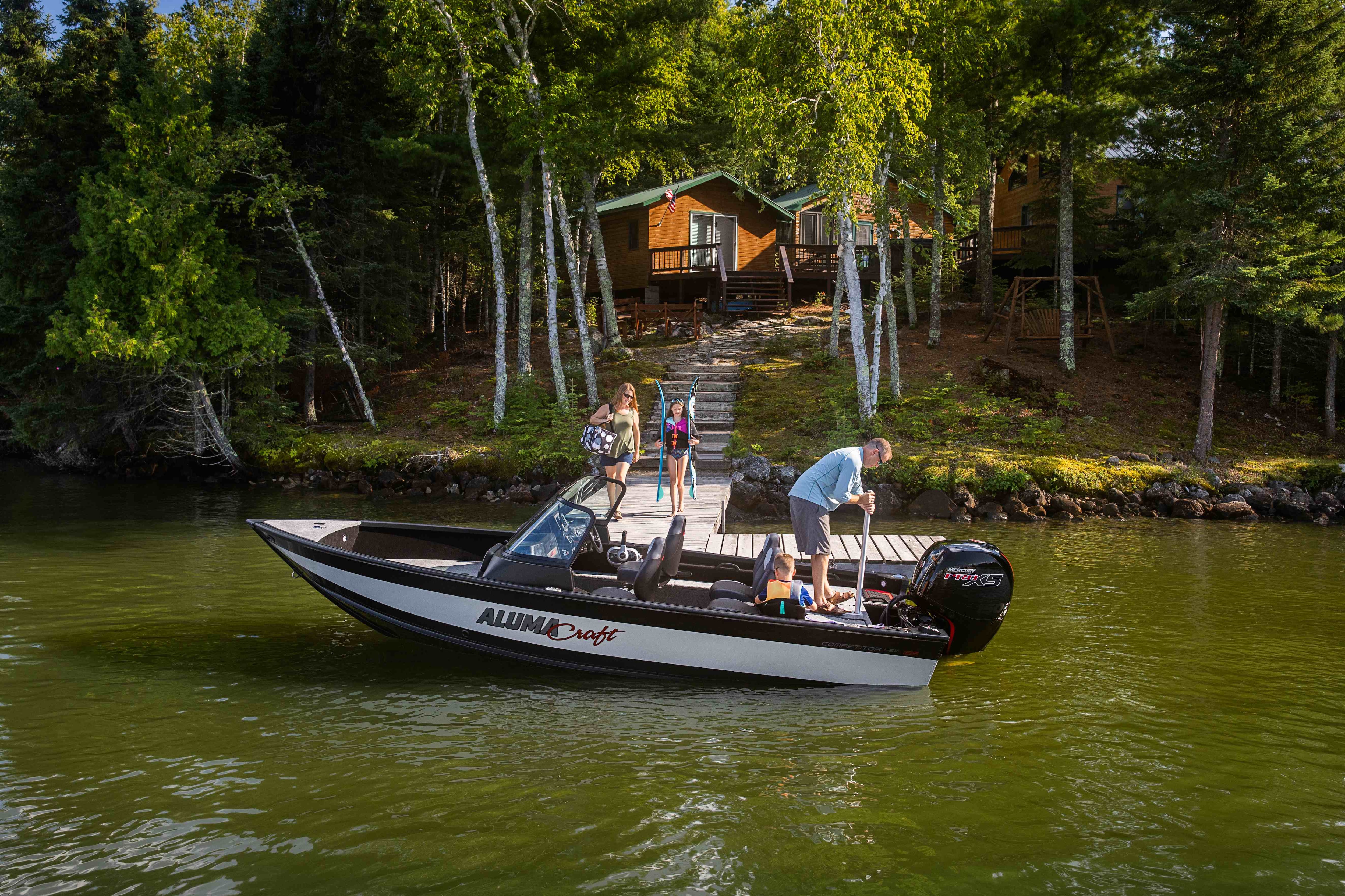 Family docking a silver black Aluminum boat 