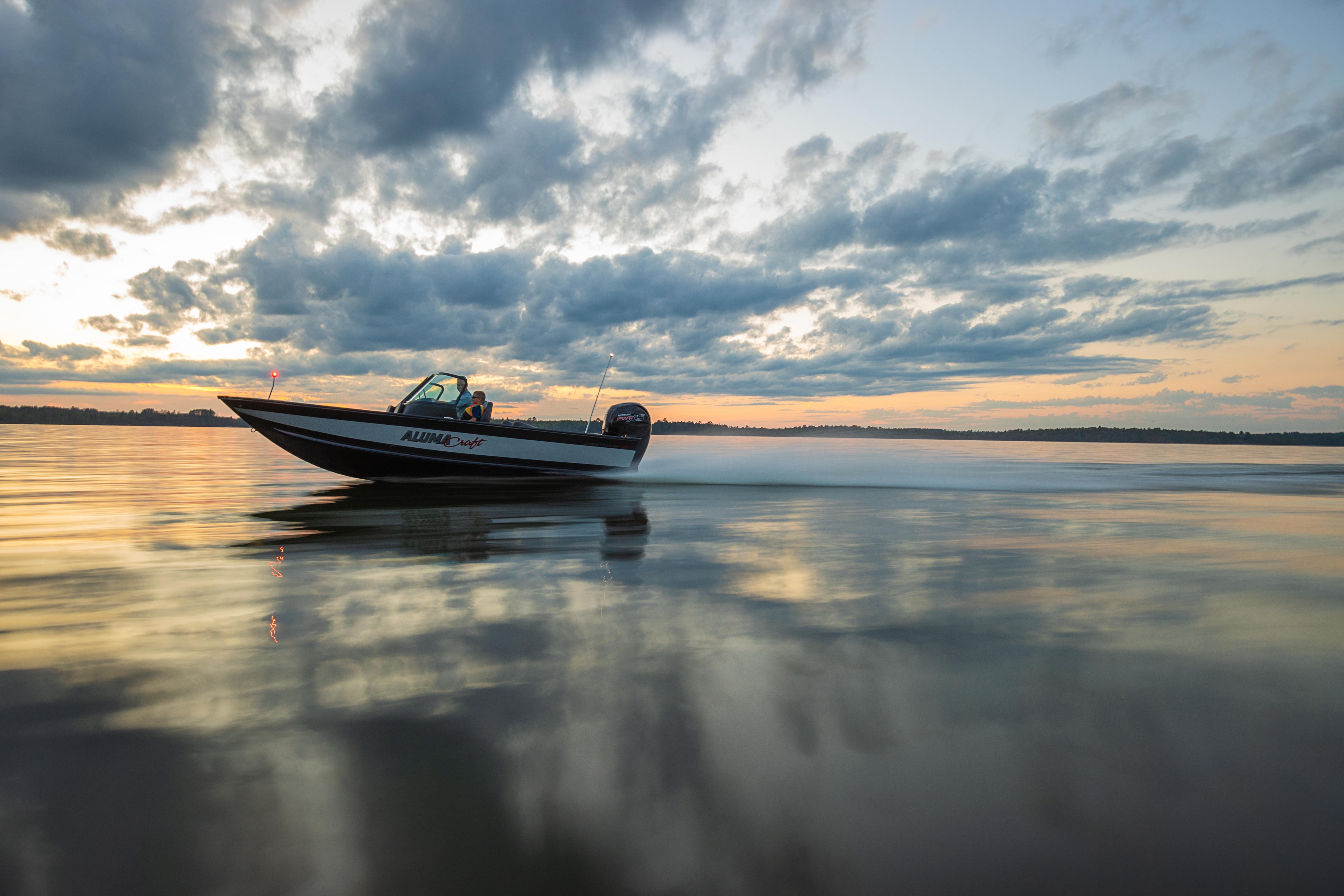 Father and son on a Fish Sport boat at the sunset