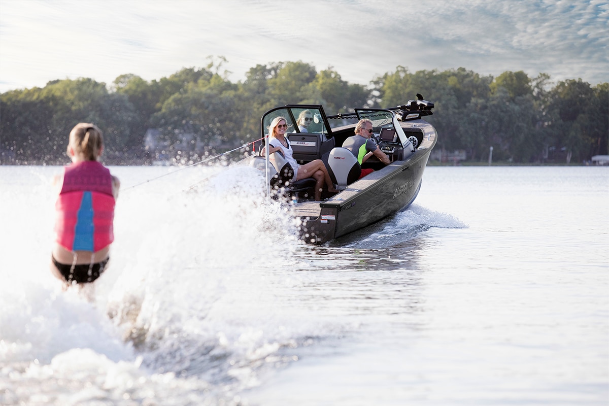 Girl water skiing with an Alumacraft Fish & Sport Black Boat