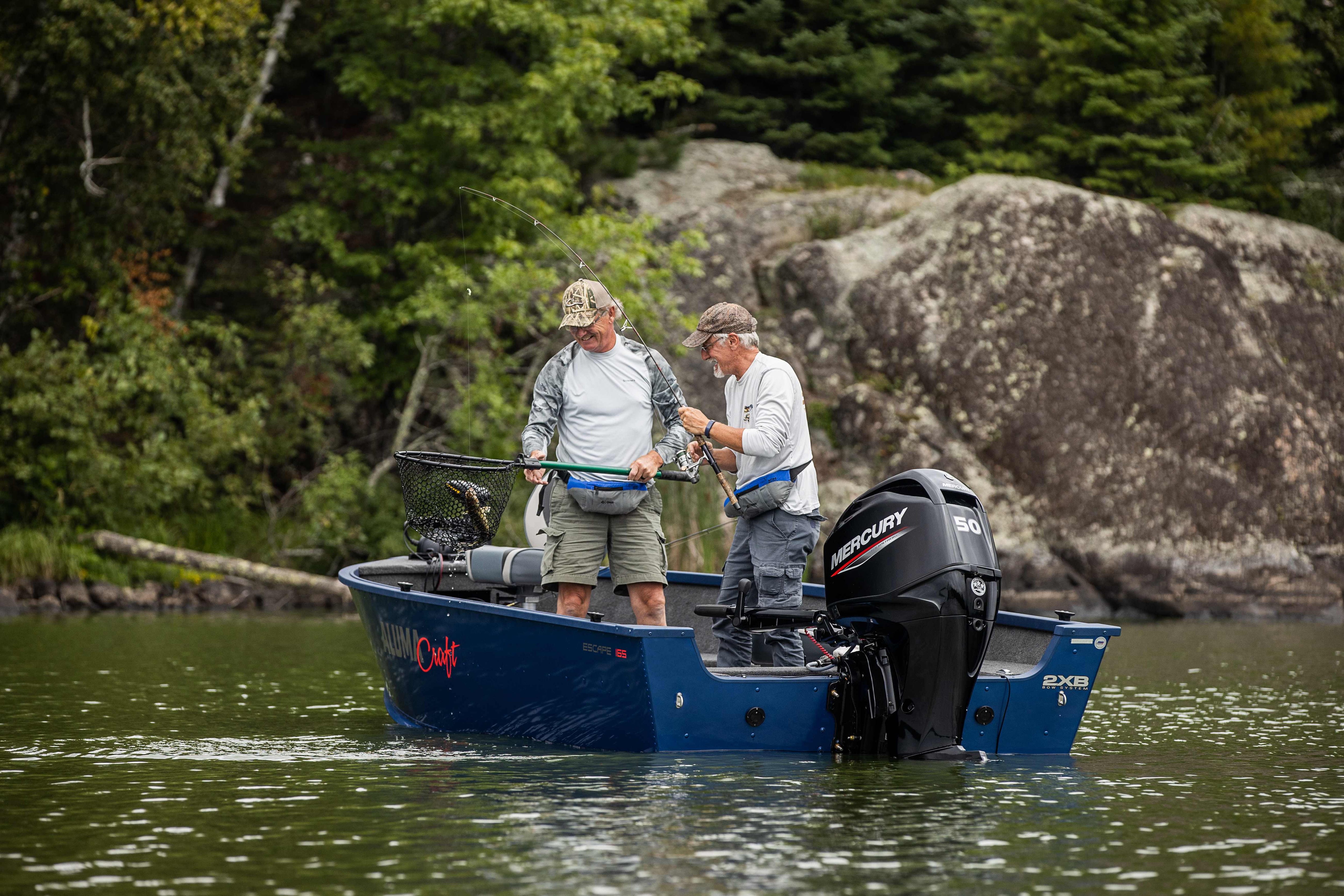 Two men fishing on a blue boat