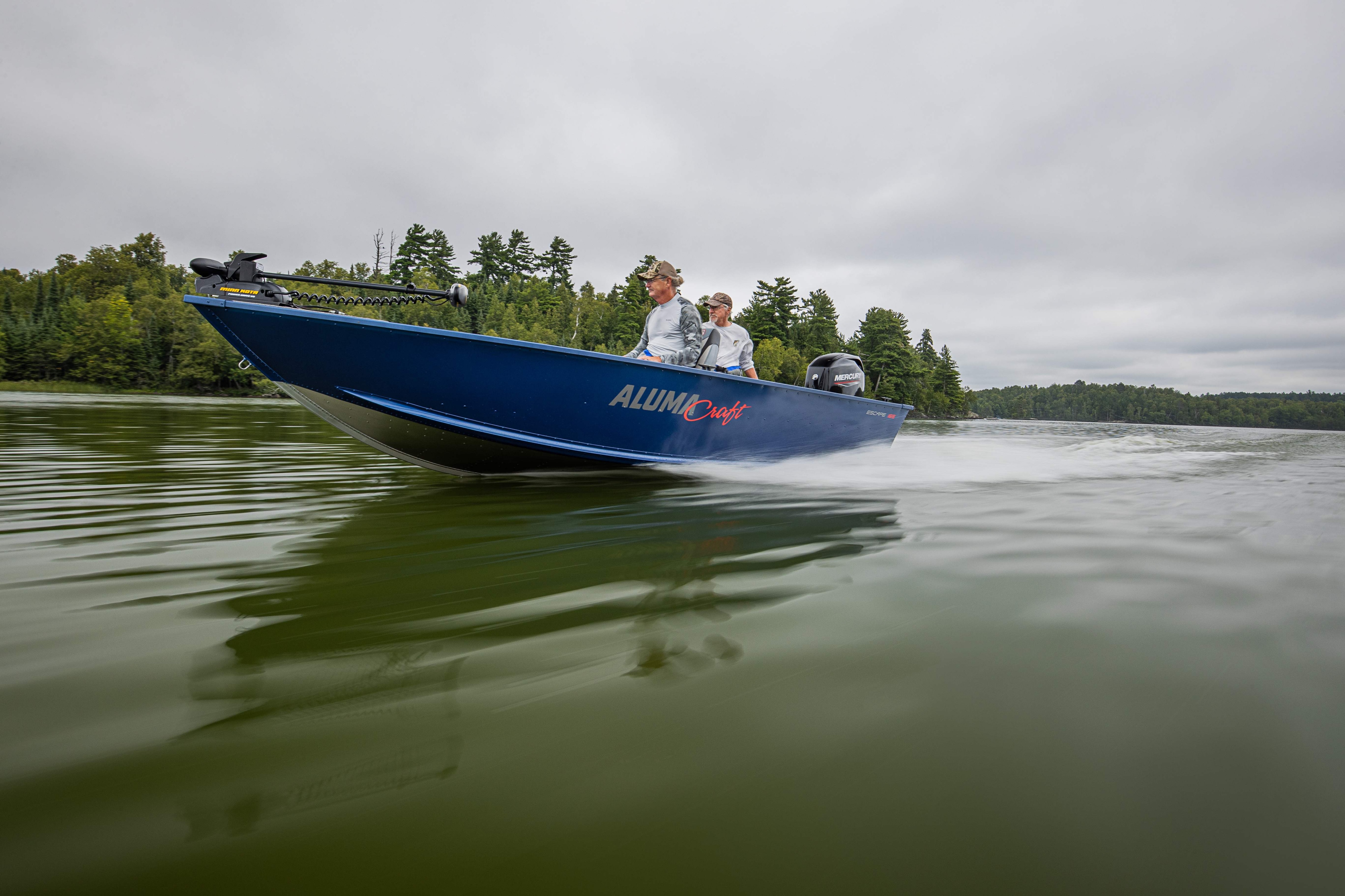Two men driving a blue boat