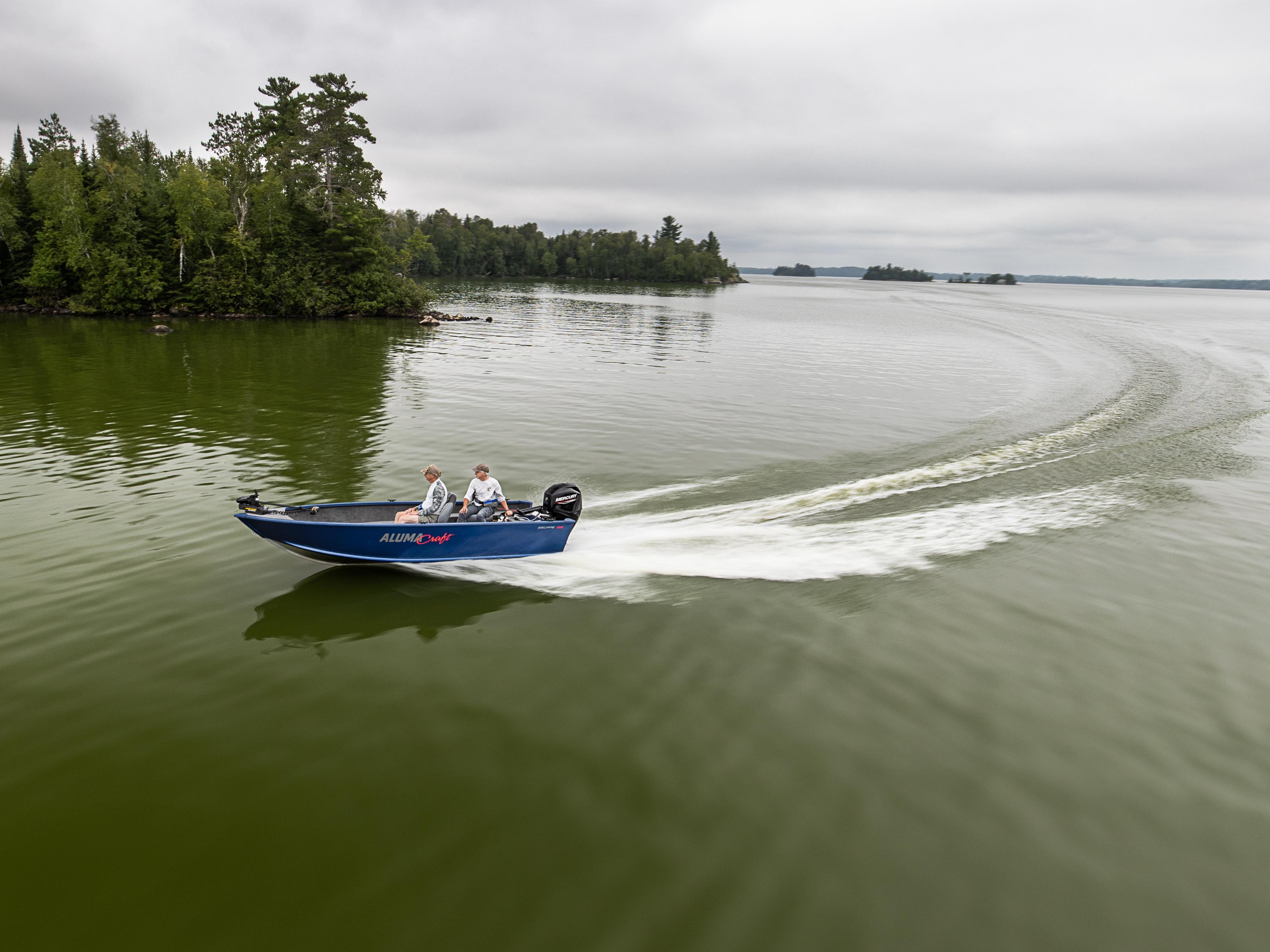 Alumacraft Multispecies Escape blue boat curving on the water