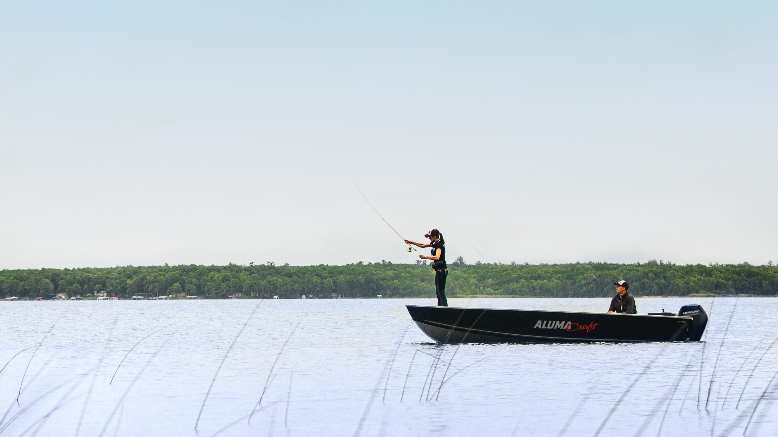 Man fly fishing on Alumacraft Hunt Utility boat v series