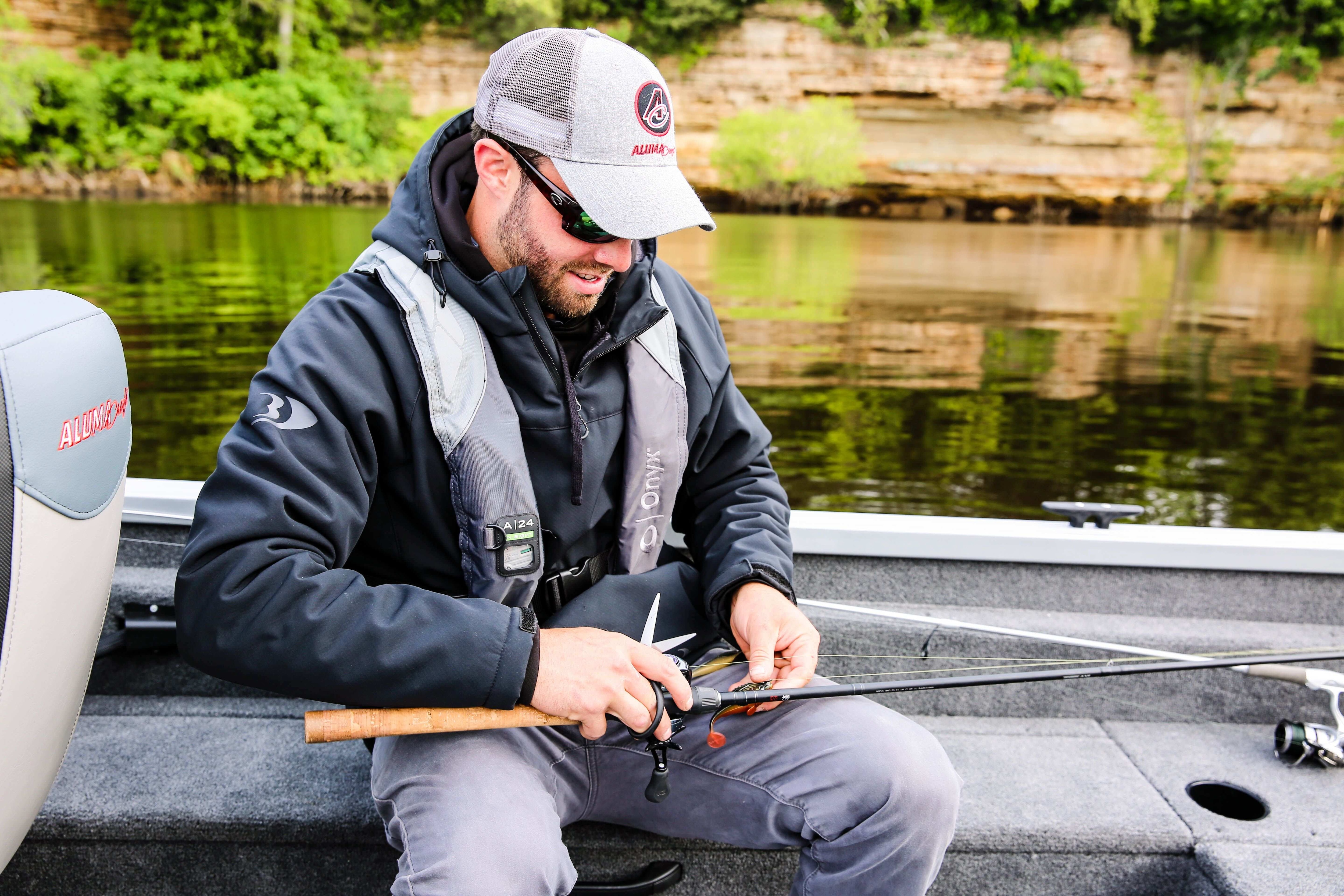 man preparing his fishing rod on a boat