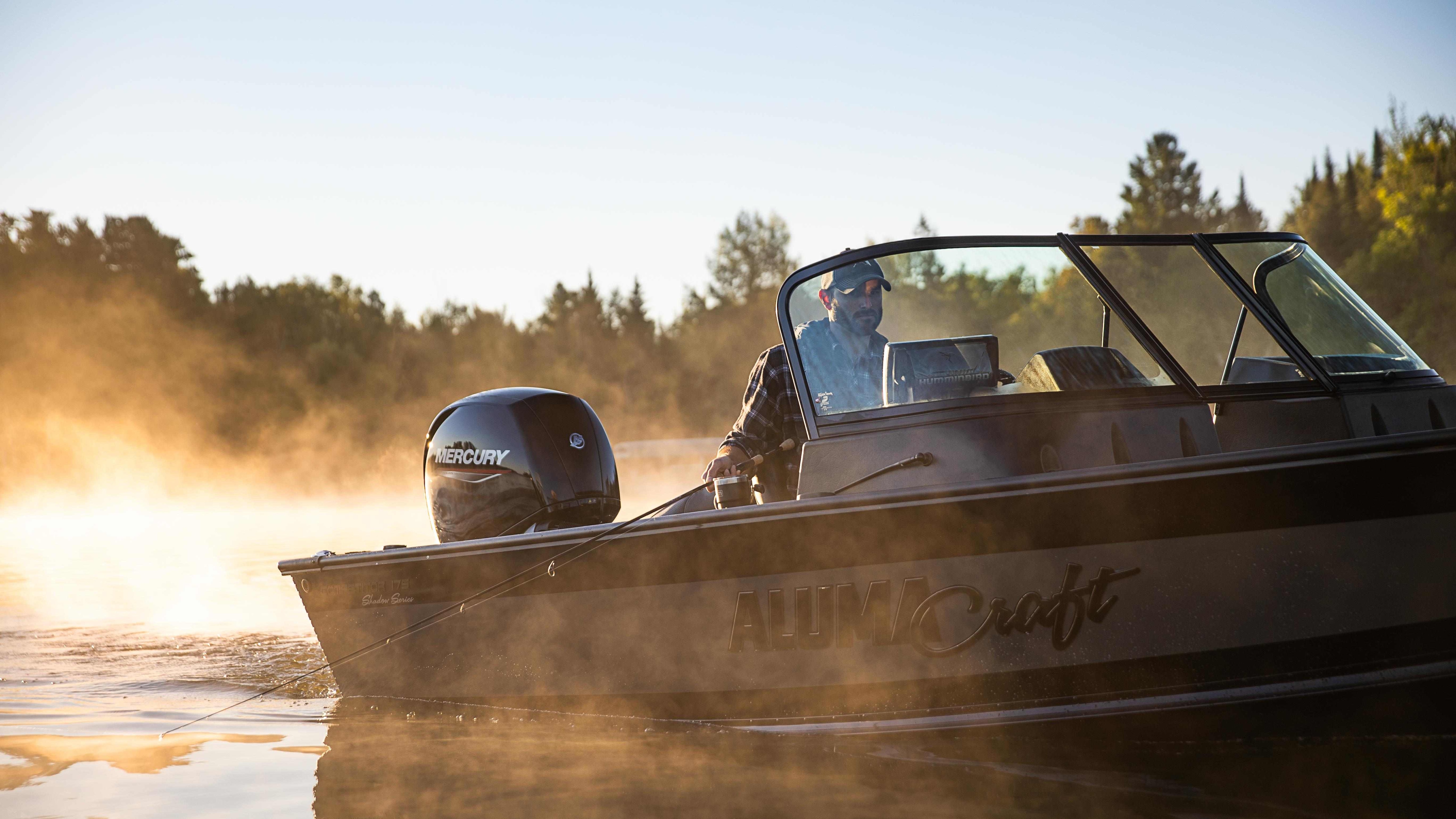 Man on his Alumacraft Aluminum fishing boat at sunrise