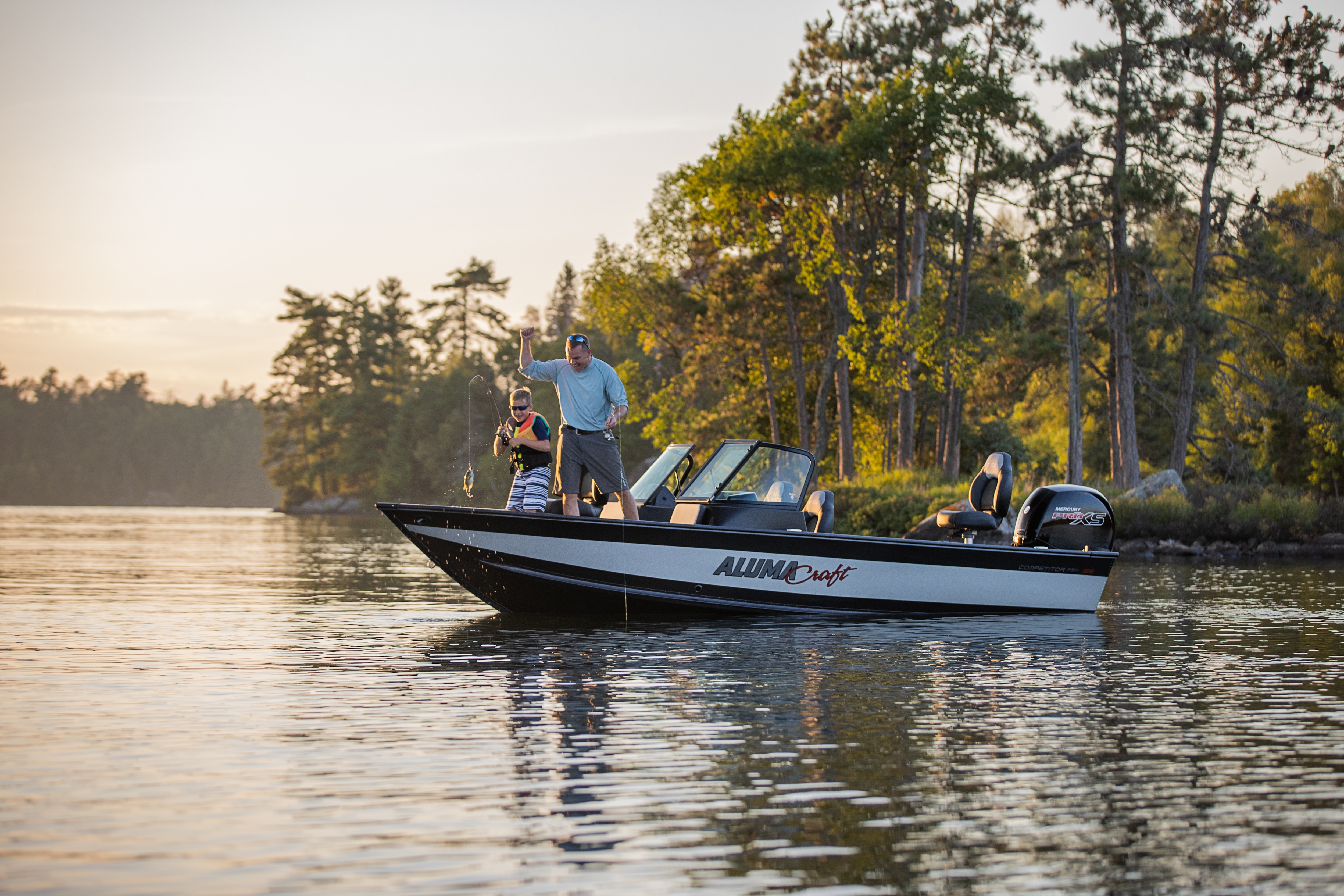 Man with his son fishing from an Alumacraft aluminum fishing boat