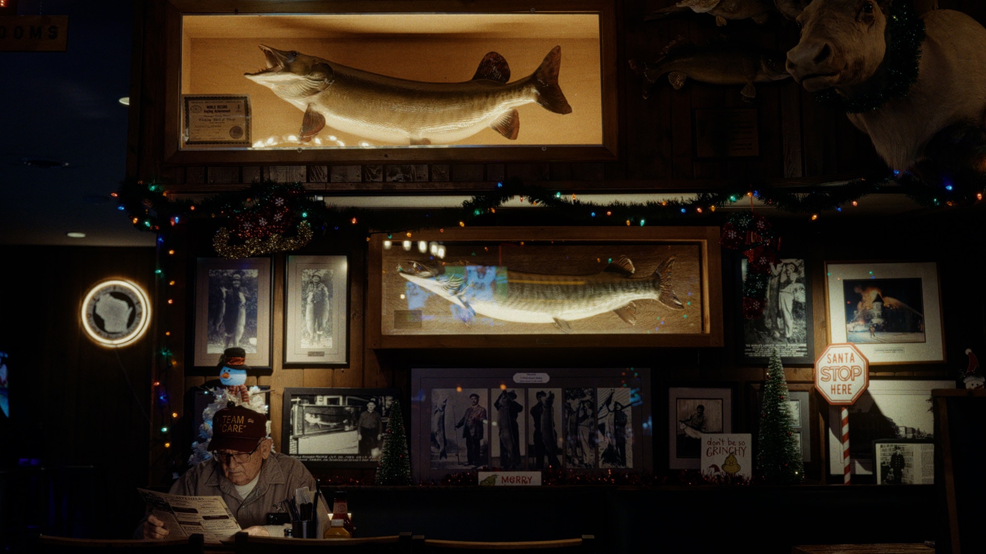 Ramsell aka &ldquo;MuskieMan&rdquo; in front of all his trophies and frames