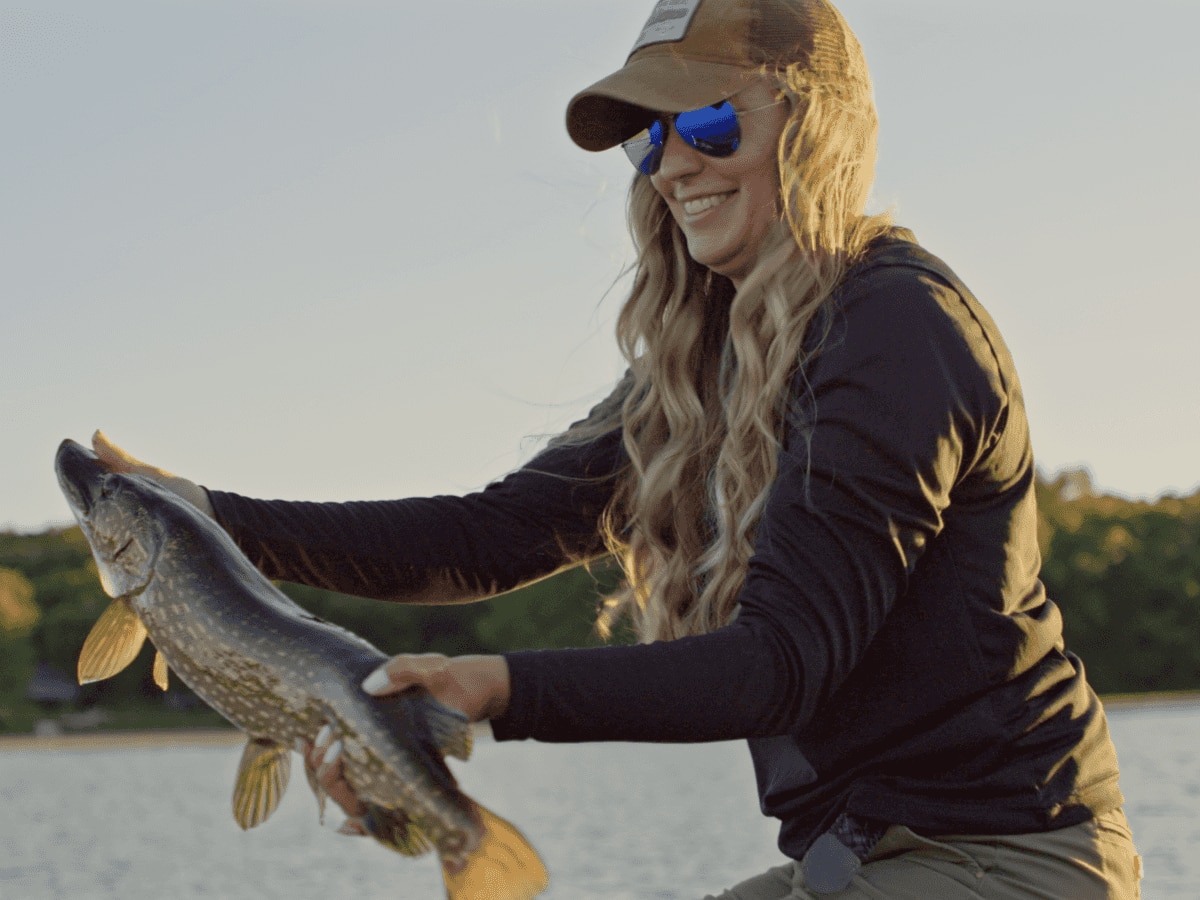 A smiling Krysten Potega that just caught a fish